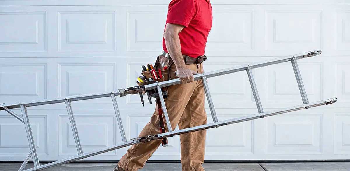 Garage door repair technician arriving with tools and ladder in Wilmington, NC