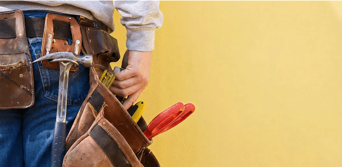 Handyman with tool belt ready for home repairs and maintenance in Wilmington, NC